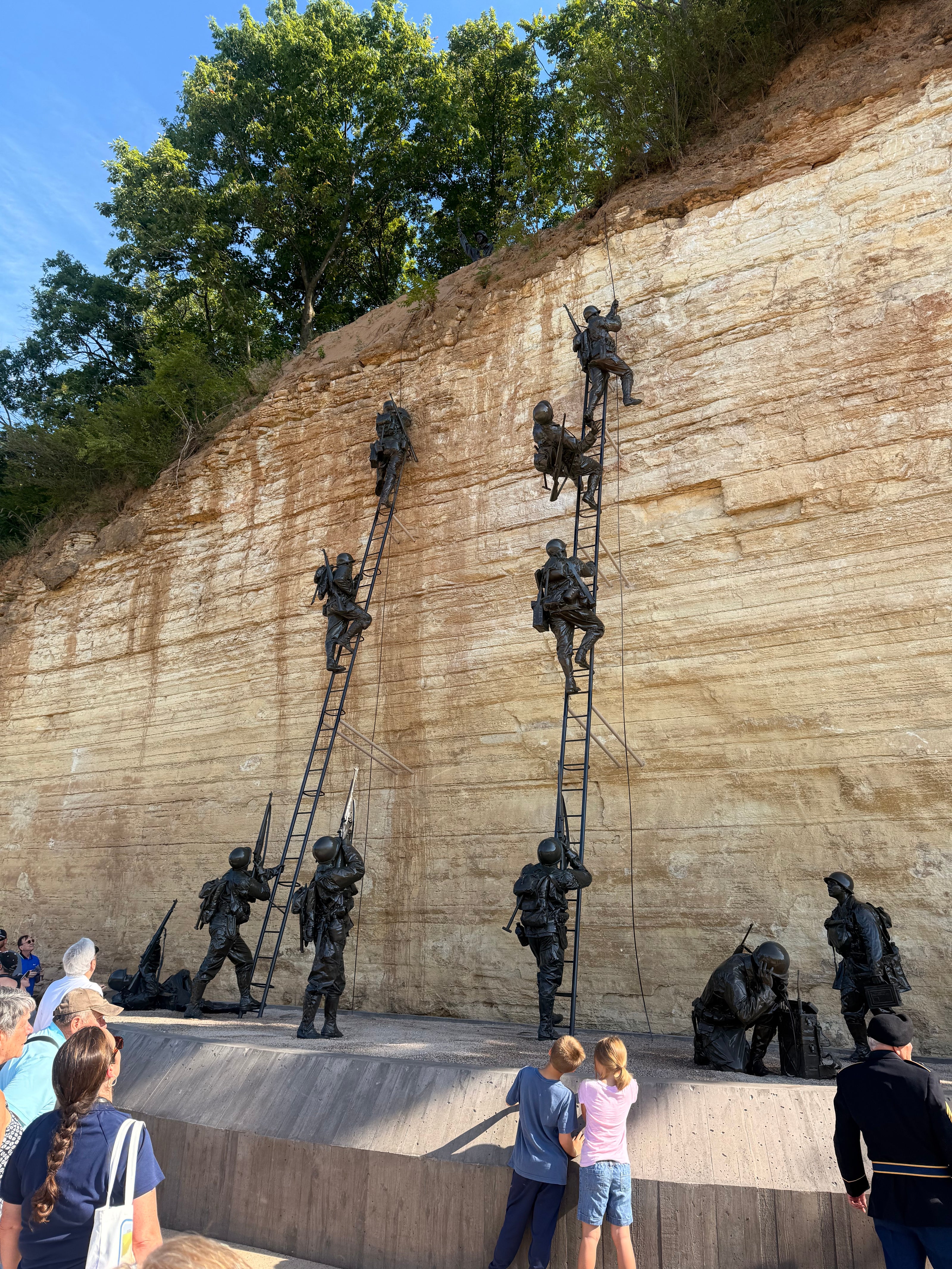 Bronze Army Ranger sculptures climbing the limestone bluff at the National Memorial of Military Ascent